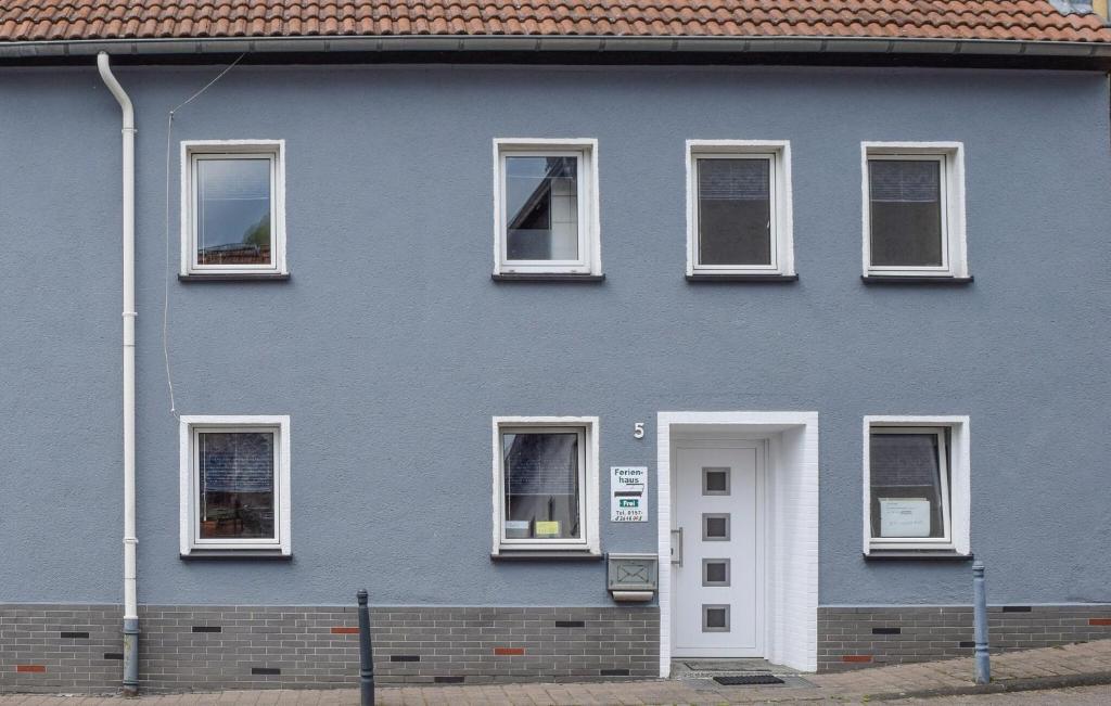 a blue house with white windows and a door at Nice Apartment In Pelm With Wifi in Pelm