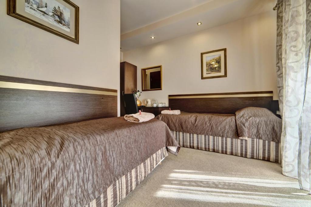 Posteľ alebo postele v izbe v ubytovaní Hotel Orlik