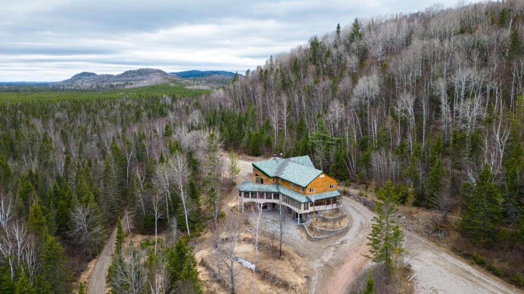 an aerial view of a house in the middle of a forest at Auberge Carcajou in Saint-David-de-Falardeau