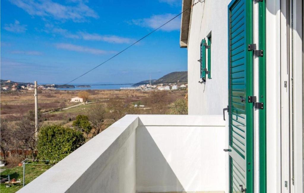 a balcony with a green door and a view of the ocean at Apartment Nedo in Supetarska Draga