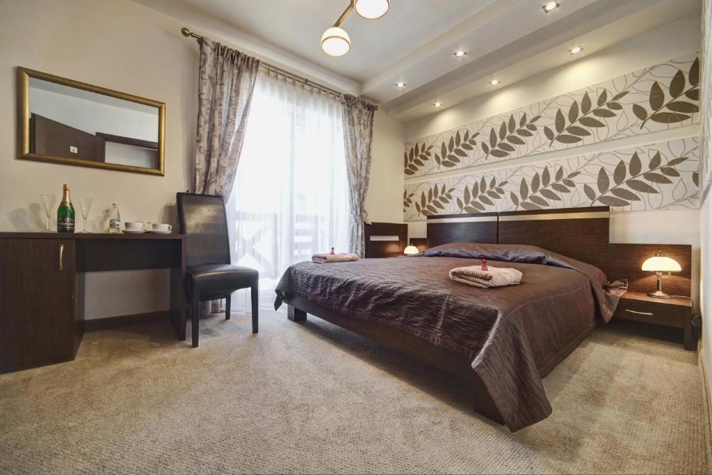 Posteľ alebo postele v izbe v ubytovaní Hotel Orlik