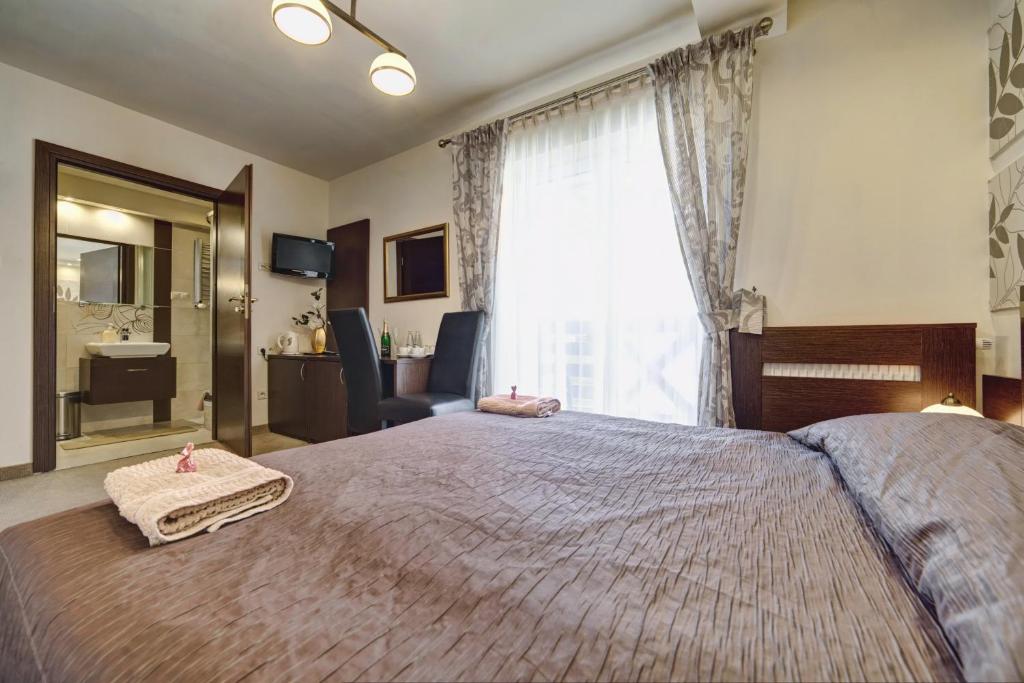 Posteľ alebo postele v izbe v ubytovaní Hotel Orlik