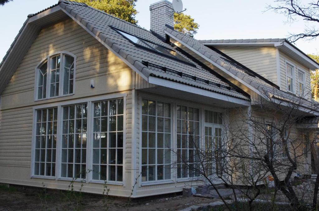 a house with a pitched roof and windows at Viva Apartment in Tallinn