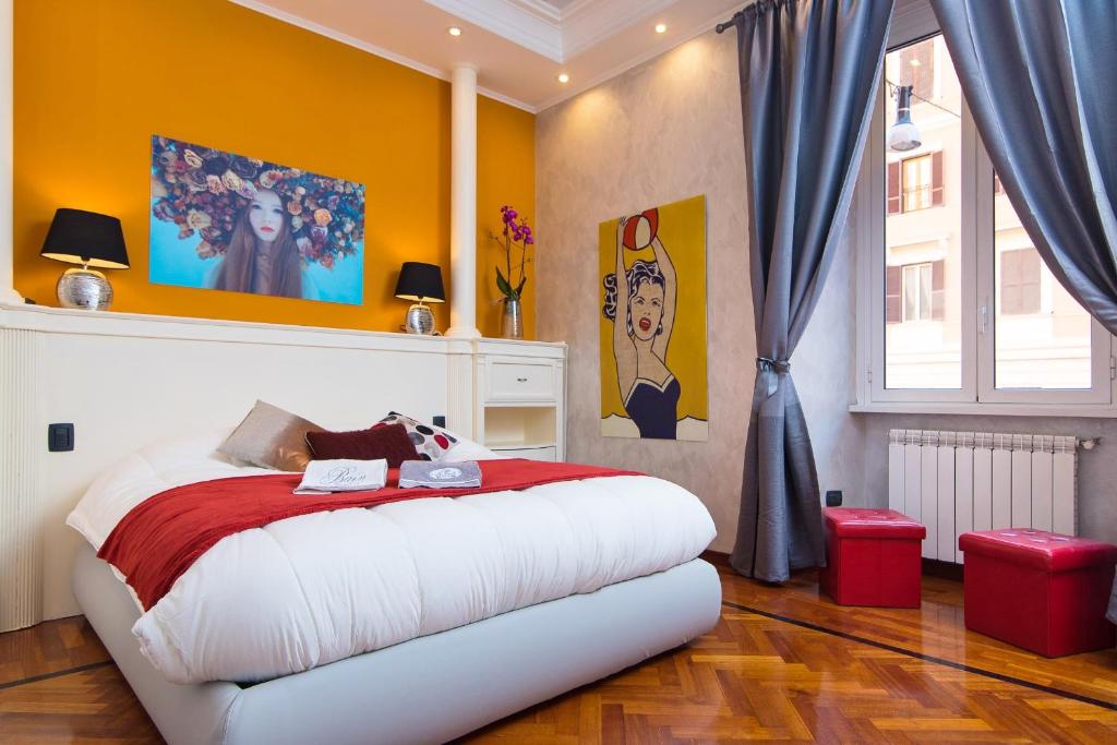 a bedroom with a large bed with yellow walls at B&B Arco Di Gallieno in Rome