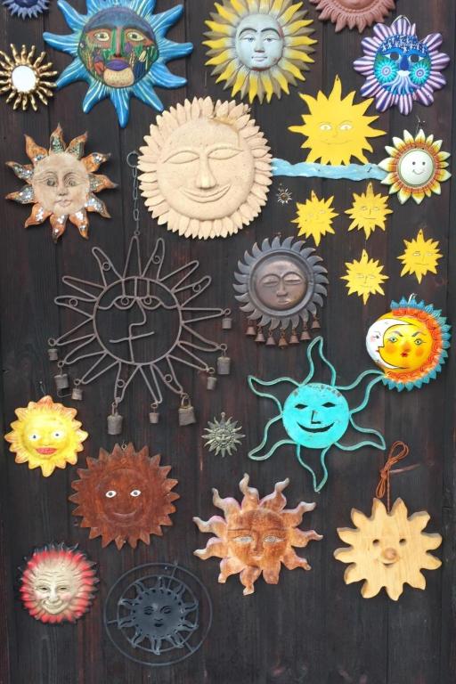 a wall with different types of sun and moon decorations at Apartment Morion by Interhome in Lenk