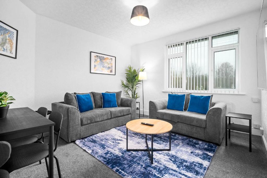 a living room with two couches and a table at Chic Two Bedroom Apartment - On Street Parking Available - Netflix - Wifi - Top Rated - 311M in Birmingham