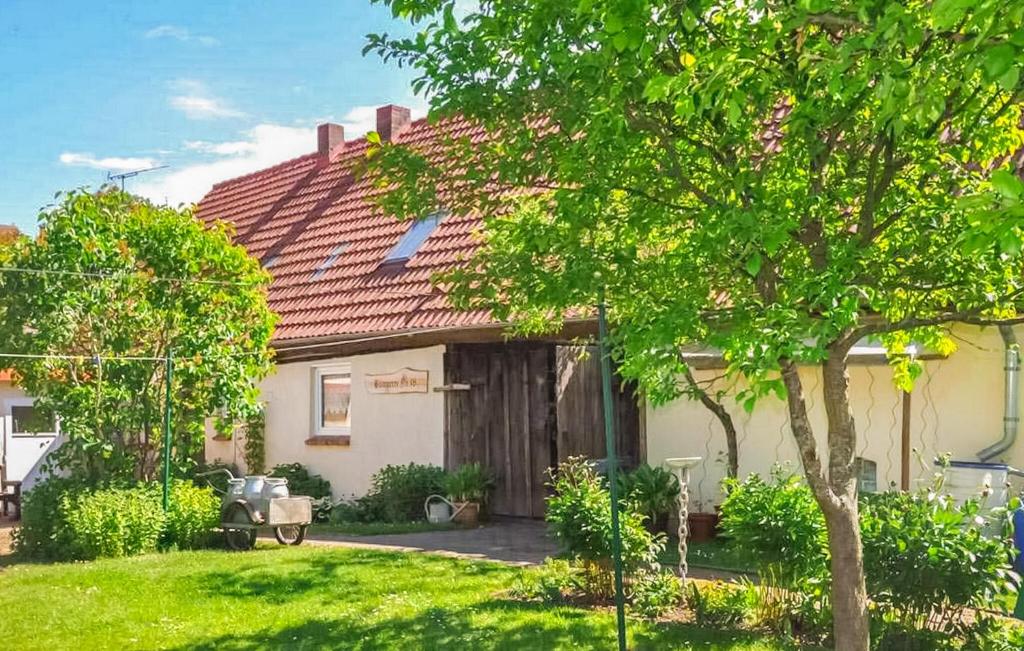 a house with a red roof and a yard at Ferienhaus Grünow in Grünow