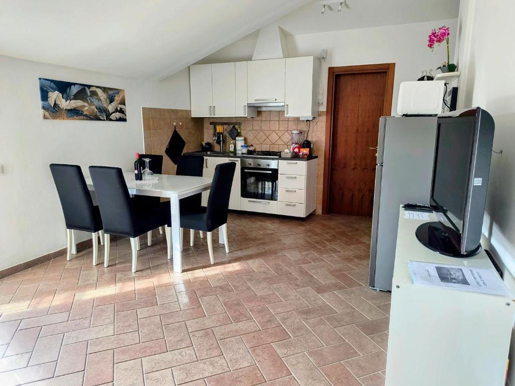 a kitchen with a table and chairs and a refrigerator at Appartamento la casa di Mary Anguillara Sabazia-Lago,Relax e Roma a portata di treno in Anguillara Sabazia