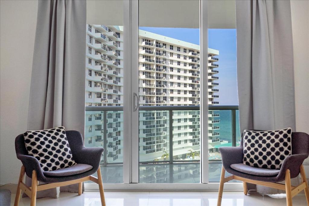 two chairs in a room with a large window at The Tides Ocean Luxury Suites in Hollywood