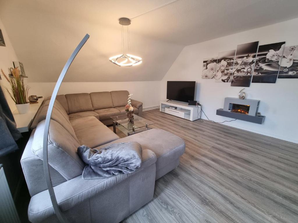 a living room with a couch and a fireplace at Haus Peter Wohnung 4 in Sankt Andreasberg