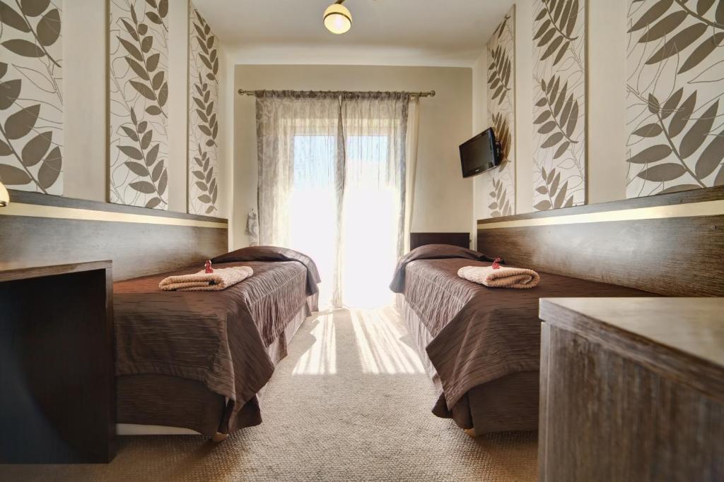 Posteľ alebo postele v izbe v ubytovaní Hotel Orlik