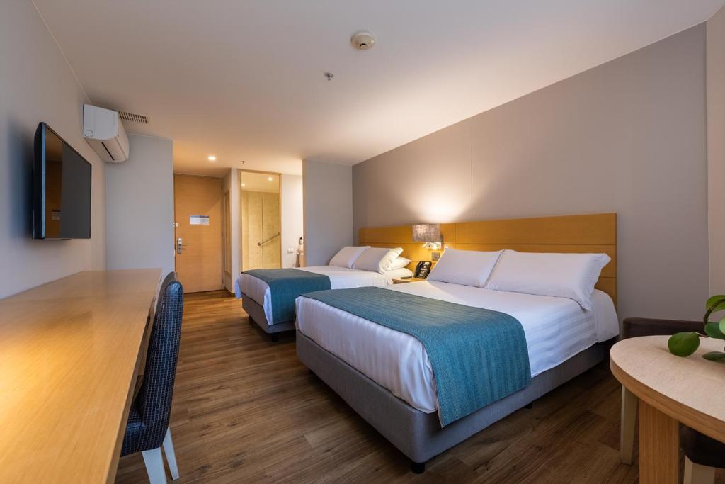 Postel nebo postele na pokoji v ubytování Hotel Estelar Blue