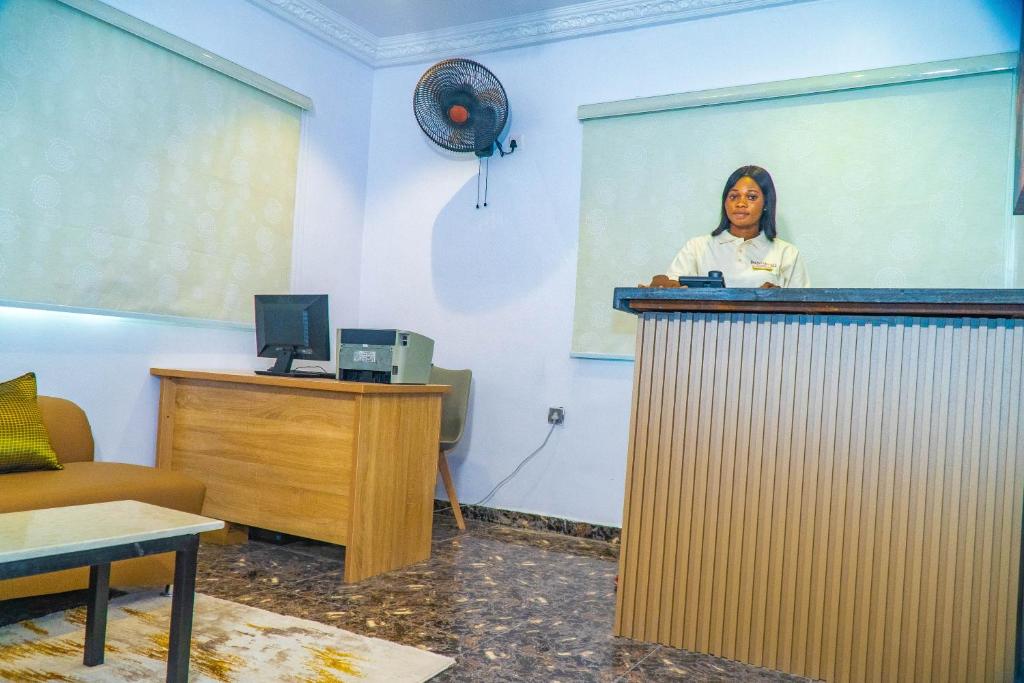 a woman standing behind a podium in a room at Ringruby Hotel, Sangotedo in Sangotedo