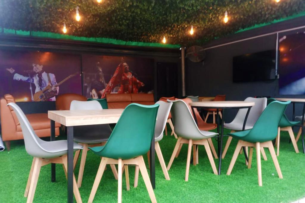 a group of chairs and a table and a stage at Ringruby Hotel, Sangotedo in Sangotedo