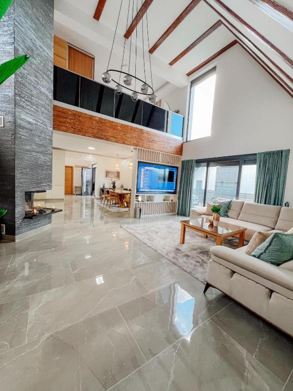 a large living room with a couch and a fireplace at Villa Bosanska Zvijezda in Vlasic