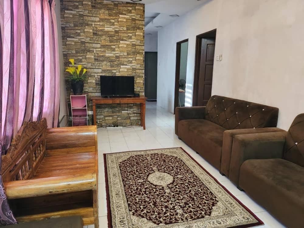 a living room with a couch and a tv at D'Haja 56 KLIA SEPANG with 3 AIRCONDS & FREE Wi-Fi in Banting