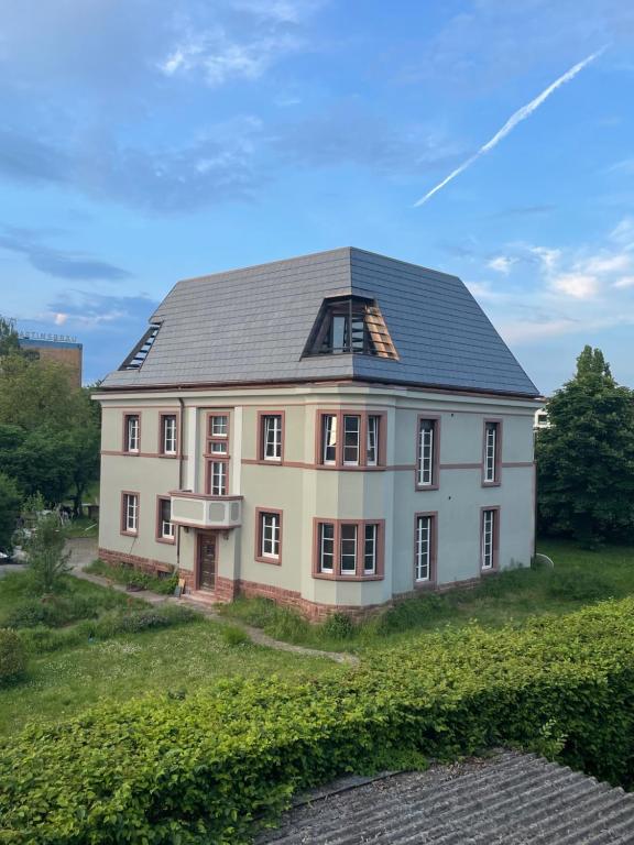 a house with a gray roof on a grass field at Gartenvilla in Marktheidenfeld