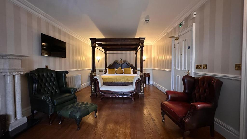 A bed or beds in a room at Sweeney's Hotel 2020 Limited