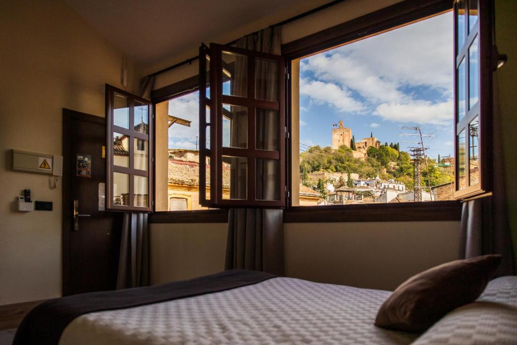 Posteľ alebo postele v izbe v ubytovaní Apartamentos Reyes Católicos