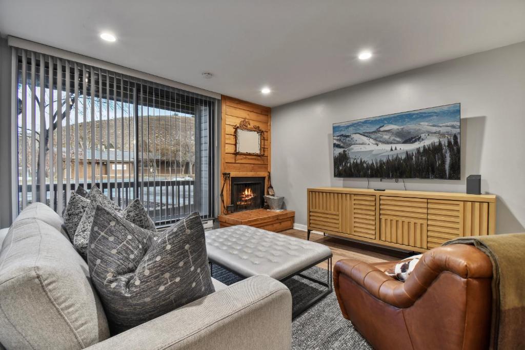 a living room with a couch and a tv at Silvertown Condos by Park City Vacations in Park City