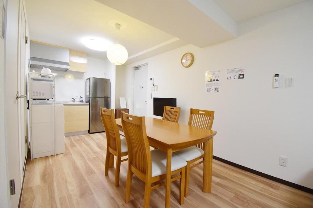 eine Küche und ein Esszimmer mit einem Holztisch und Stühlen in der Unterkunft Hostel In Kyoto Gion - Vacation STAY 13450v in Giommachi