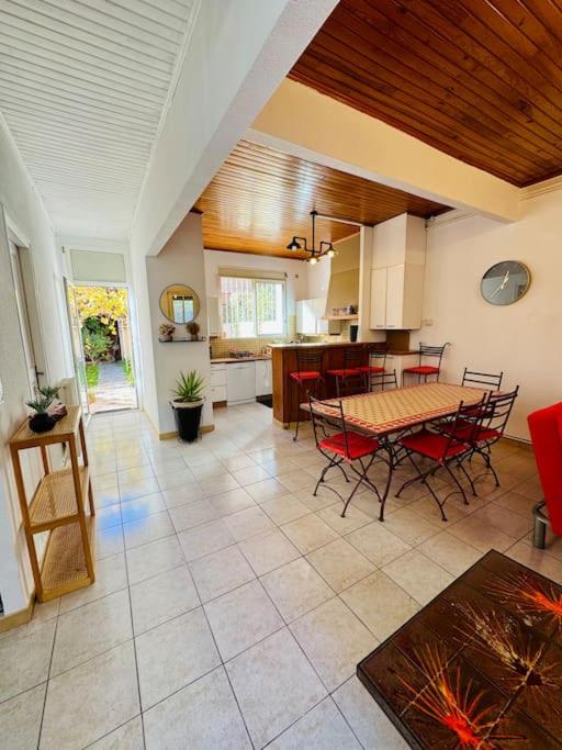 une cuisine et une salle à manger avec une table et des chaises dans l'établissement Maison centre ville avec jardin, à Perpignan