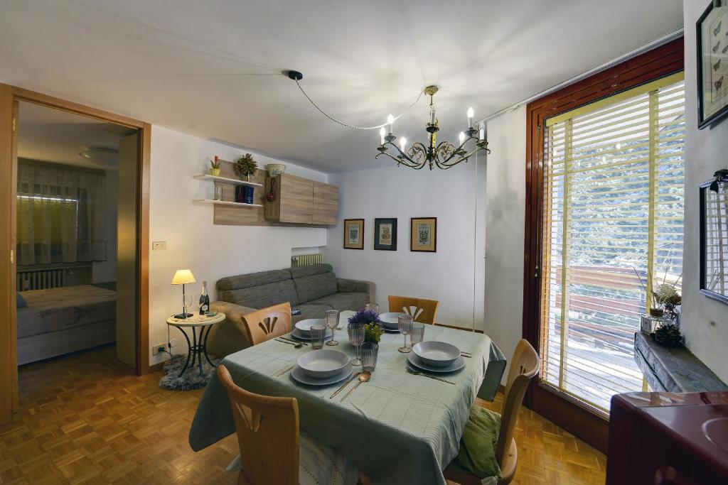 Un comedor con una mesa y una sala de estar. en Dulci du Mont Blanc, en Courmayeur