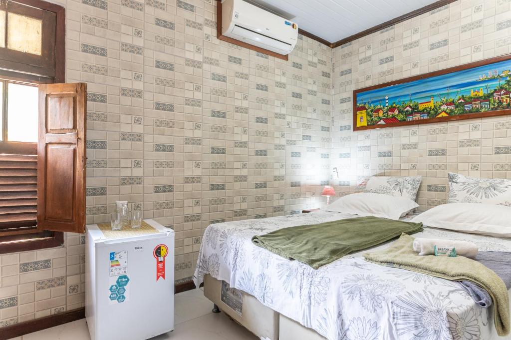 Cama ou camas em um quarto em Pousada Flor de Olinda