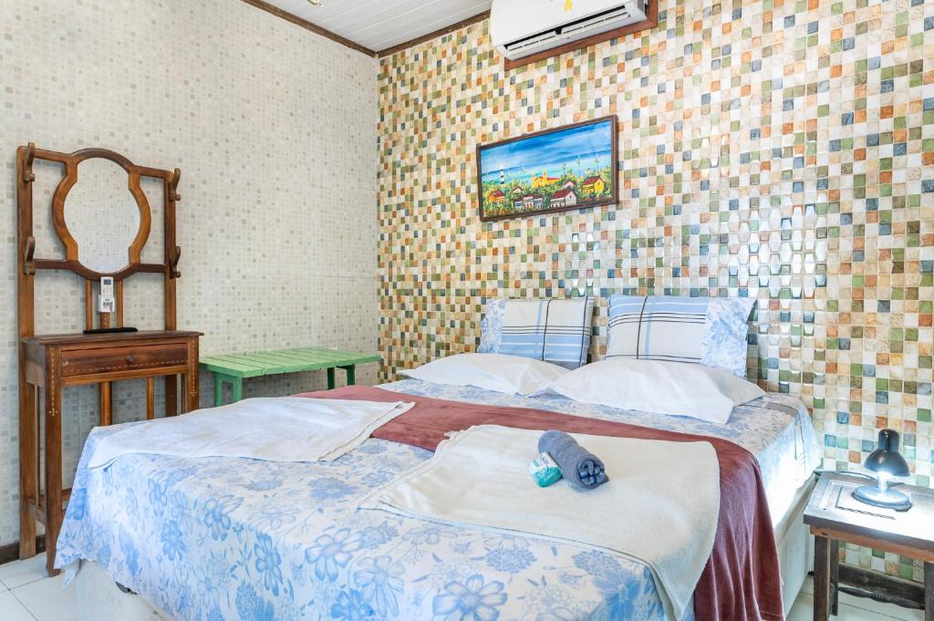 Cama ou camas em um quarto em Pousada Flor de Olinda