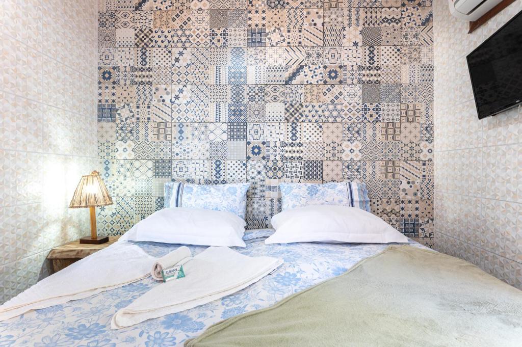 Cama ou camas em um quarto em Pousada Flor de Olinda