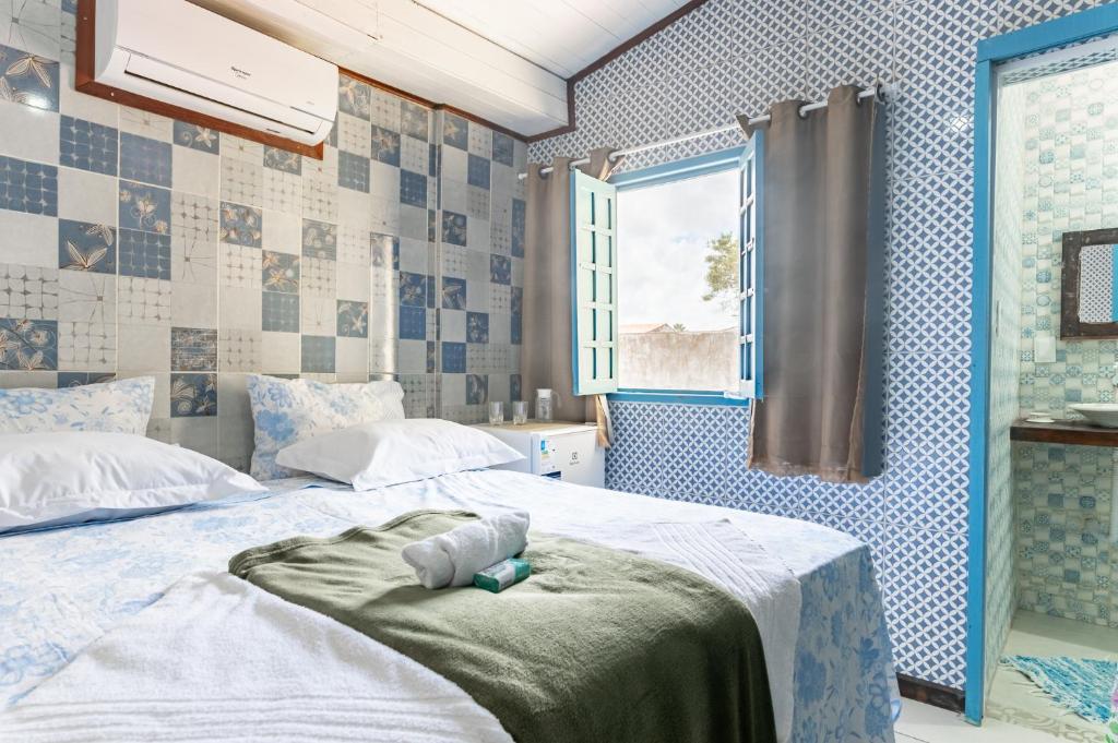 Cama ou camas em um quarto em Pousada Flor de Olinda