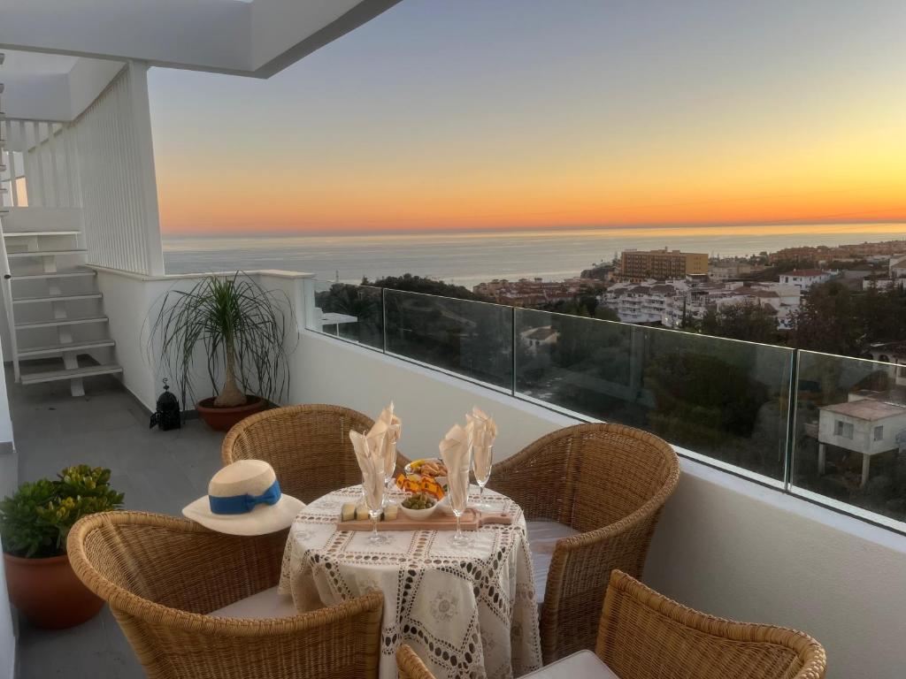a table on a balcony with a view of the ocean at Amazing Penthouse in Costa del Sol in Rincón de la Victoria