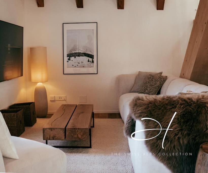 a living room with a couch and a coffee table at Hidden Retreats The GlacierDoor in Frutigen