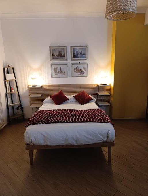 a bedroom with a large bed with two red pillows at La Dolce Vita, Vomero in Naples