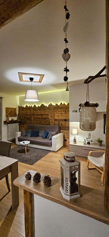 a living room with a couch and a table at Appartamento "Roby" in centro Cavalese in Cavalese