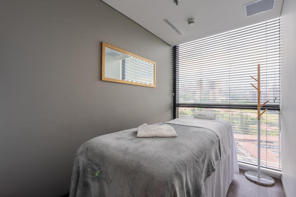 Postel nebo postele na pokoji v ubytování Hotel Estelar Square
