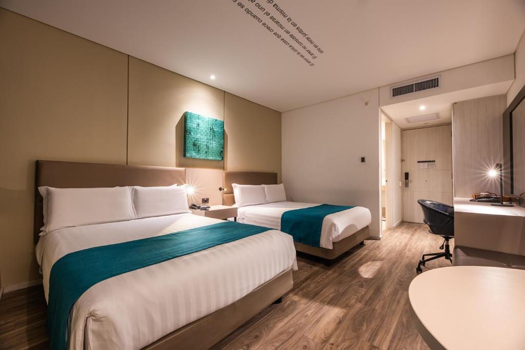 Postel nebo postele na pokoji v ubytování Hotel Estelar Square