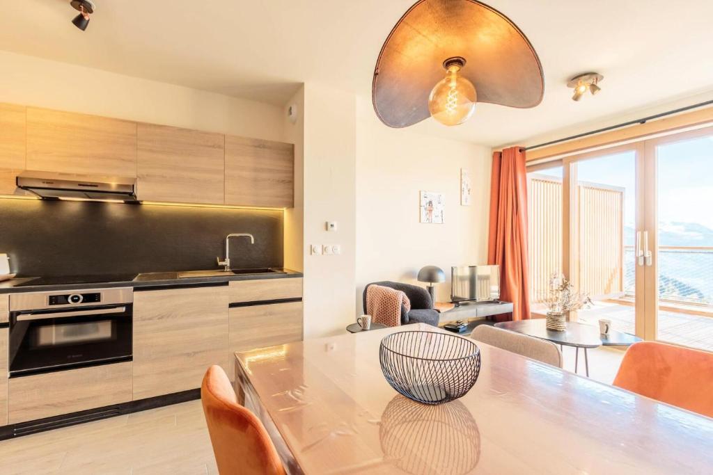 une cuisine avec une table et une salle à manger dans l'établissement Résidence Le Ridge - RIDGE 107 MAE-5031, à Arc 1600