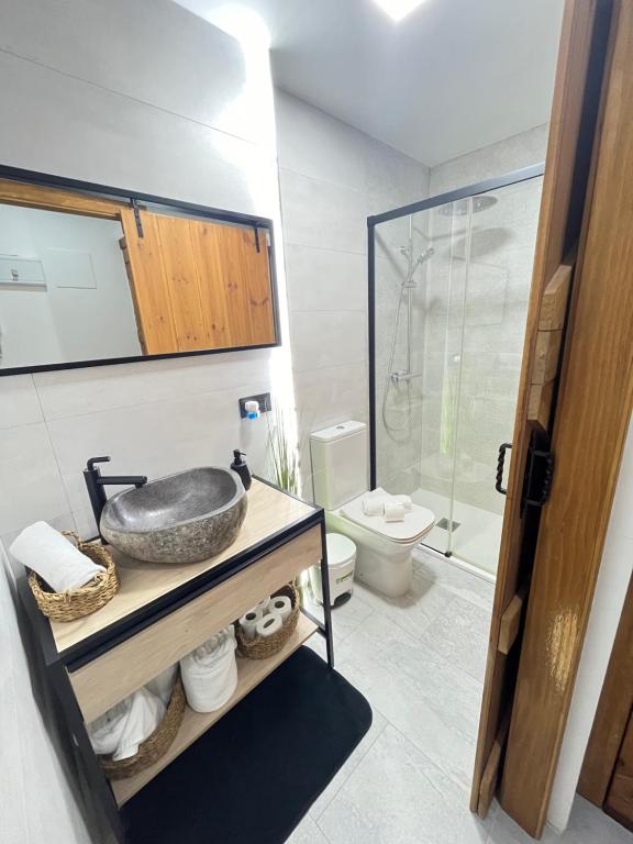 a bathroom with a sink and a shower at Madrid Confort Suites in Madrid