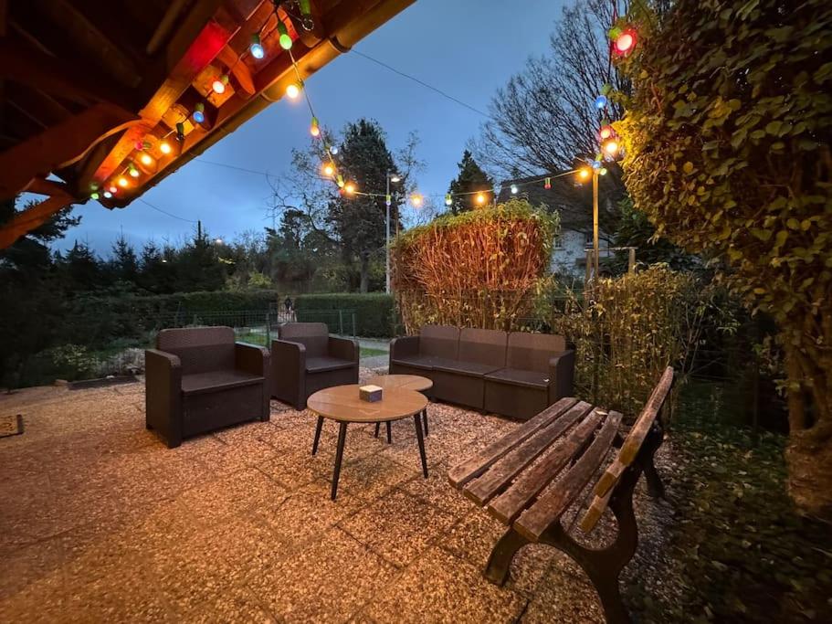 a patio with a table and couches and a bench at Havre de paix au cœur des vignes pour 4 à 6 personnes in Epfig