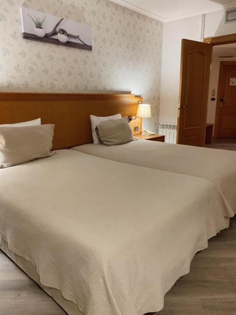 Uma cama ou camas num quarto em Hotel Lusitano