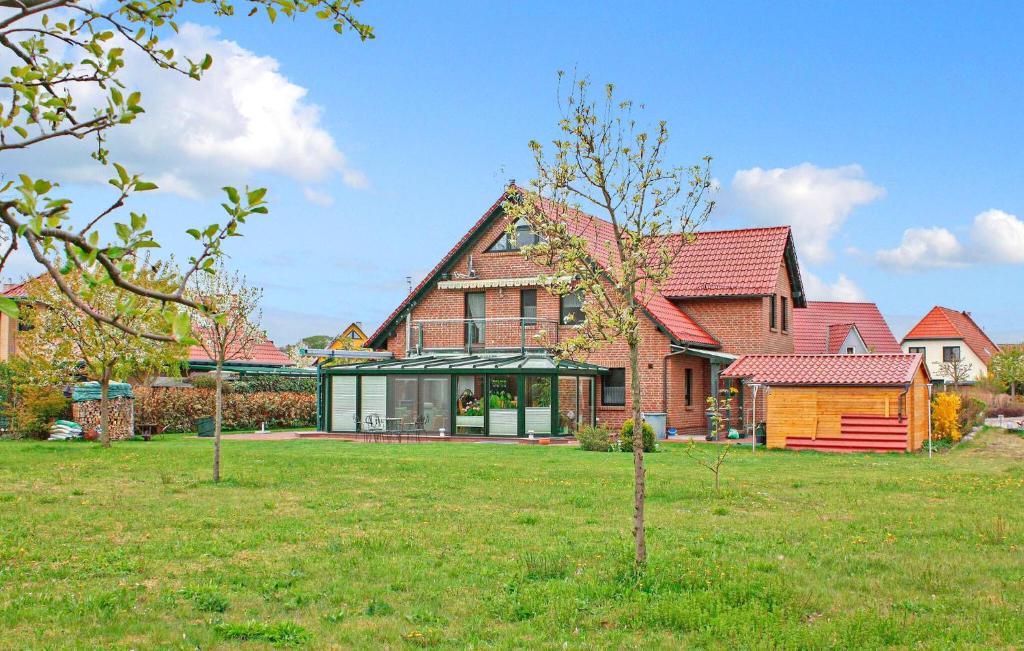 a large brick house with a green yard at Ferienwohnung Klink in Klink