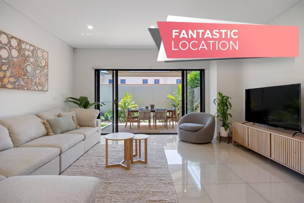 a living room with a couch and a tv at Vera on Penzance - 3BR, Parking, Wifi in Glenelg
