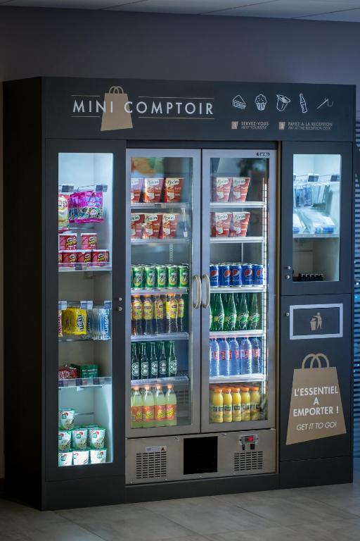 a mini corruption refrigerator in a store with drinks at Campanile Dijon Centre - Gare in Dijon