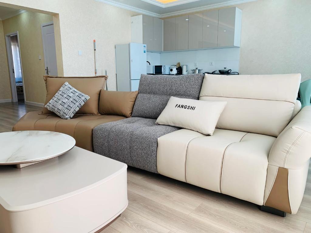 a living room with a brown and white couch at In the central of Ulaanbaatar, Selbe Comfort Apartment, 9f 187 in Ulaanbaatar