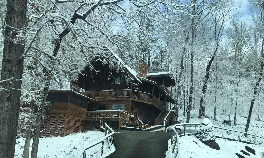 a cabin in the woods in the snow at Bears Lair cabin Chalet in Sevierville