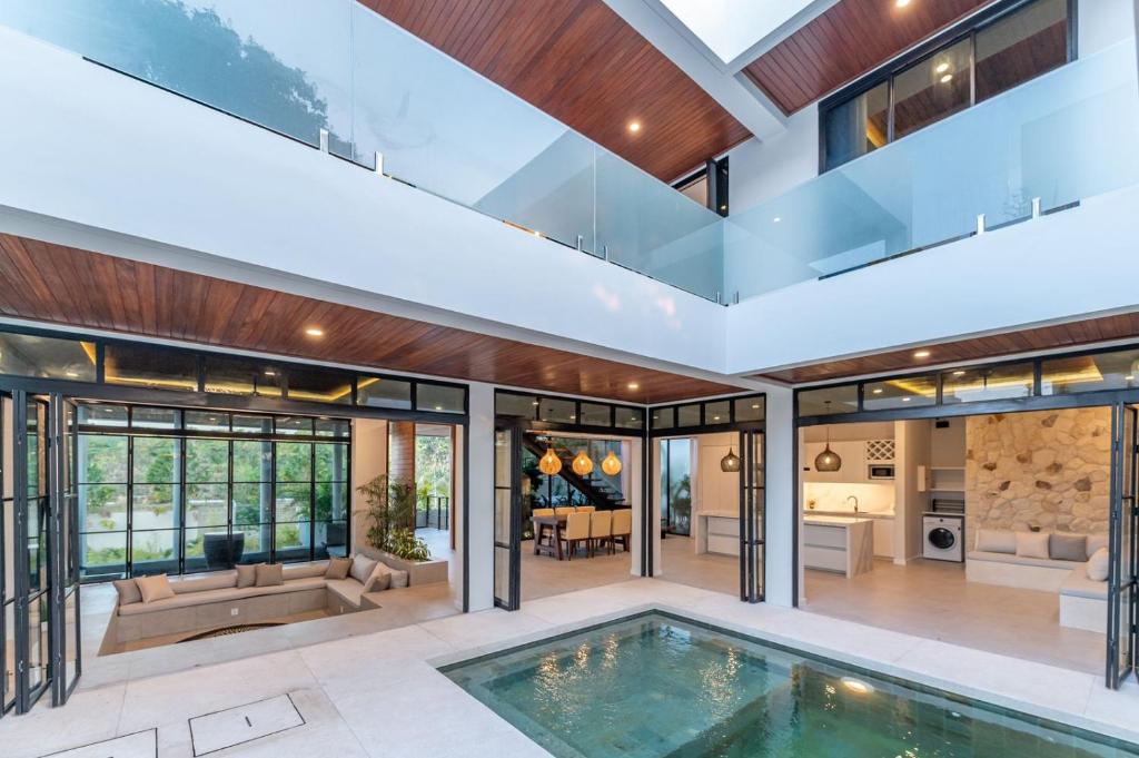 an open house with a pool in a house at Luxury Ocean Dream Villa in Uluwatu