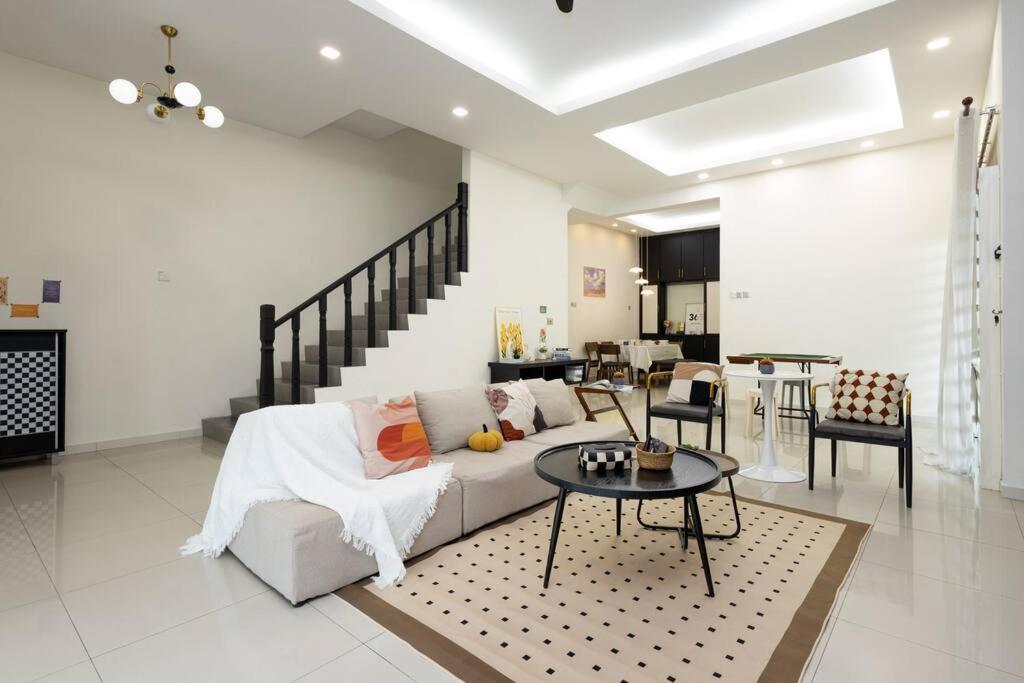 a living room with a couch and a table at Retro Homestay Ipoh - Semi D 15pax Wedding in Ipoh