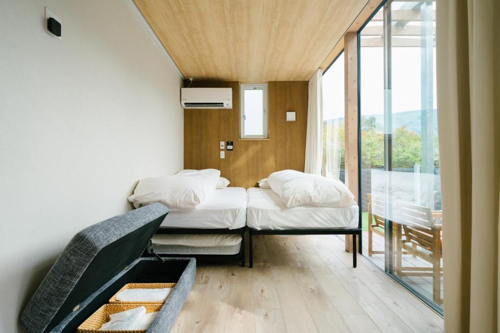 Postel nebo postele na pokoji v ubytování グランステイ湯布院 GranStay YUFUIN