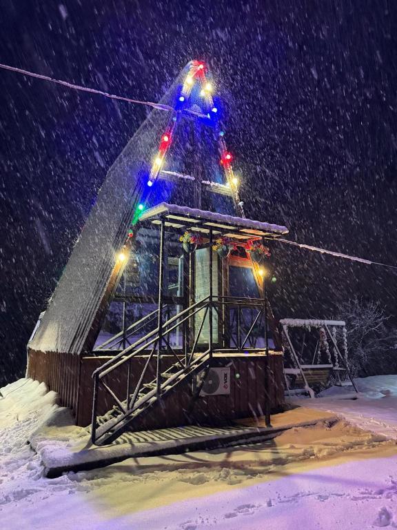 a ski lift with lights on it in the snow at Paradise Keda in Keda